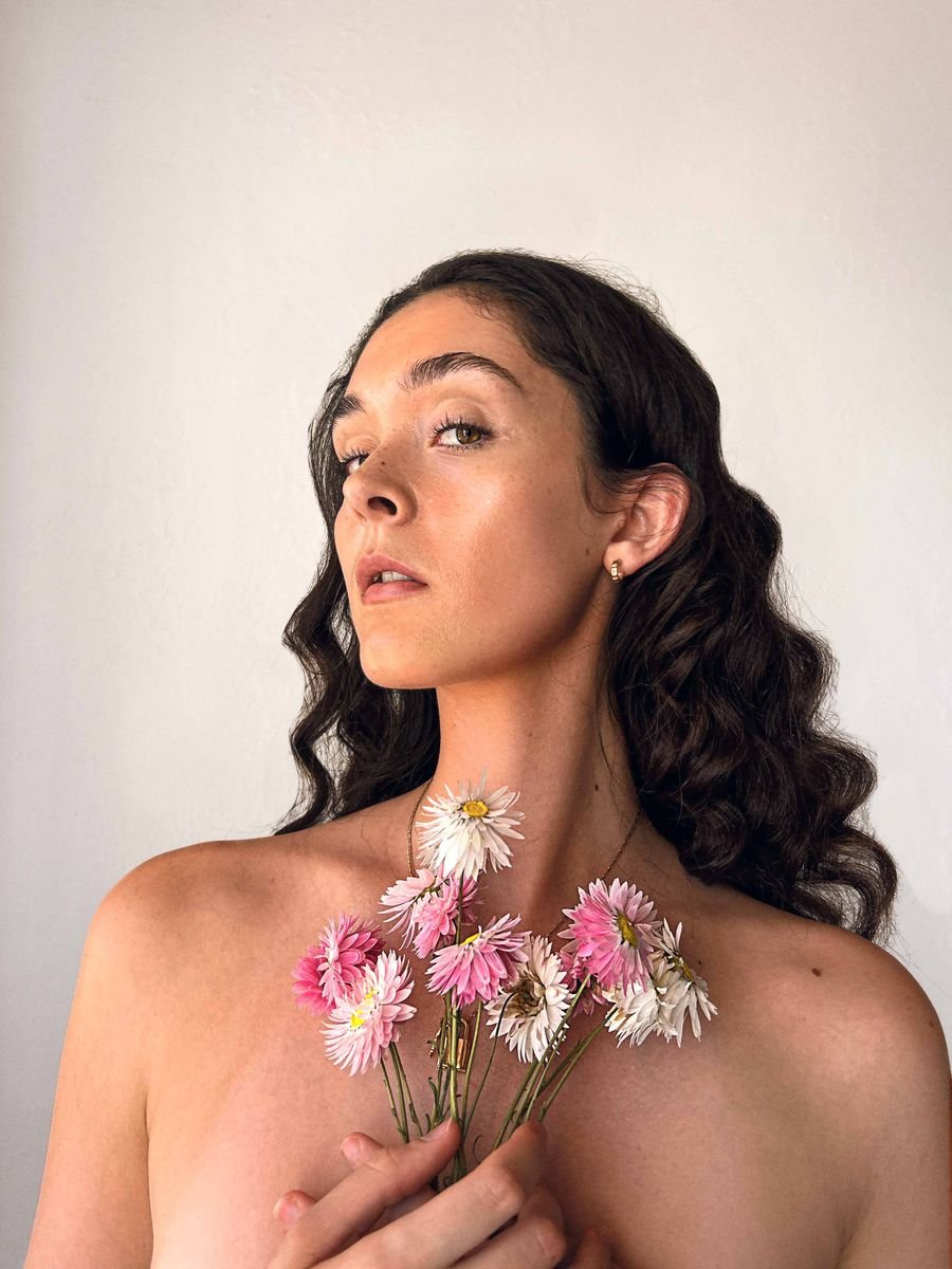 Close portrait of a model holding pink flowers
